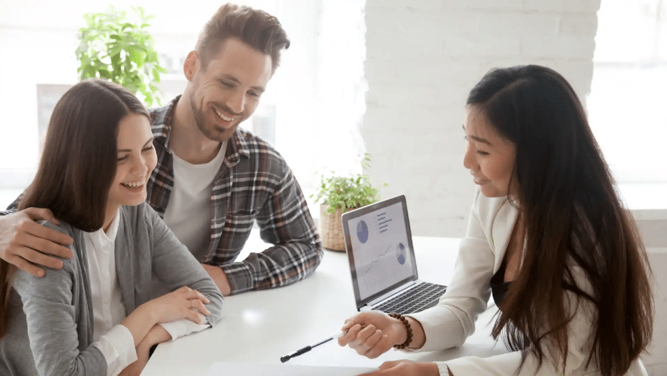 A young couple meeting with an insurance broker to find the best cover