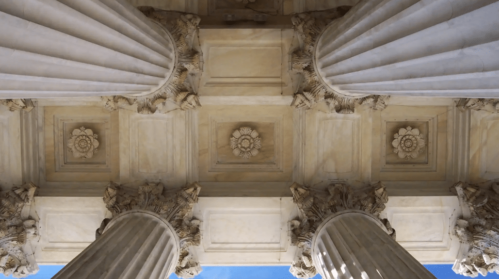 Upward view of pillars representing the support of an insurance claims process