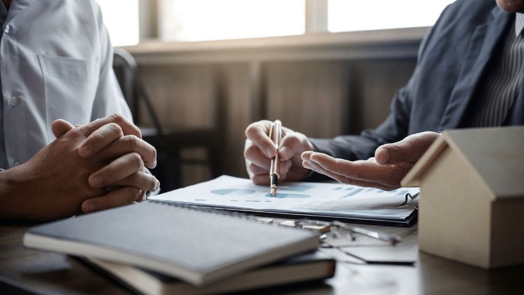 An insurance broker guiding someone through their personal home insurance policy.