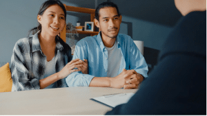 Couple meeting with insurance broker to find best insurance rates